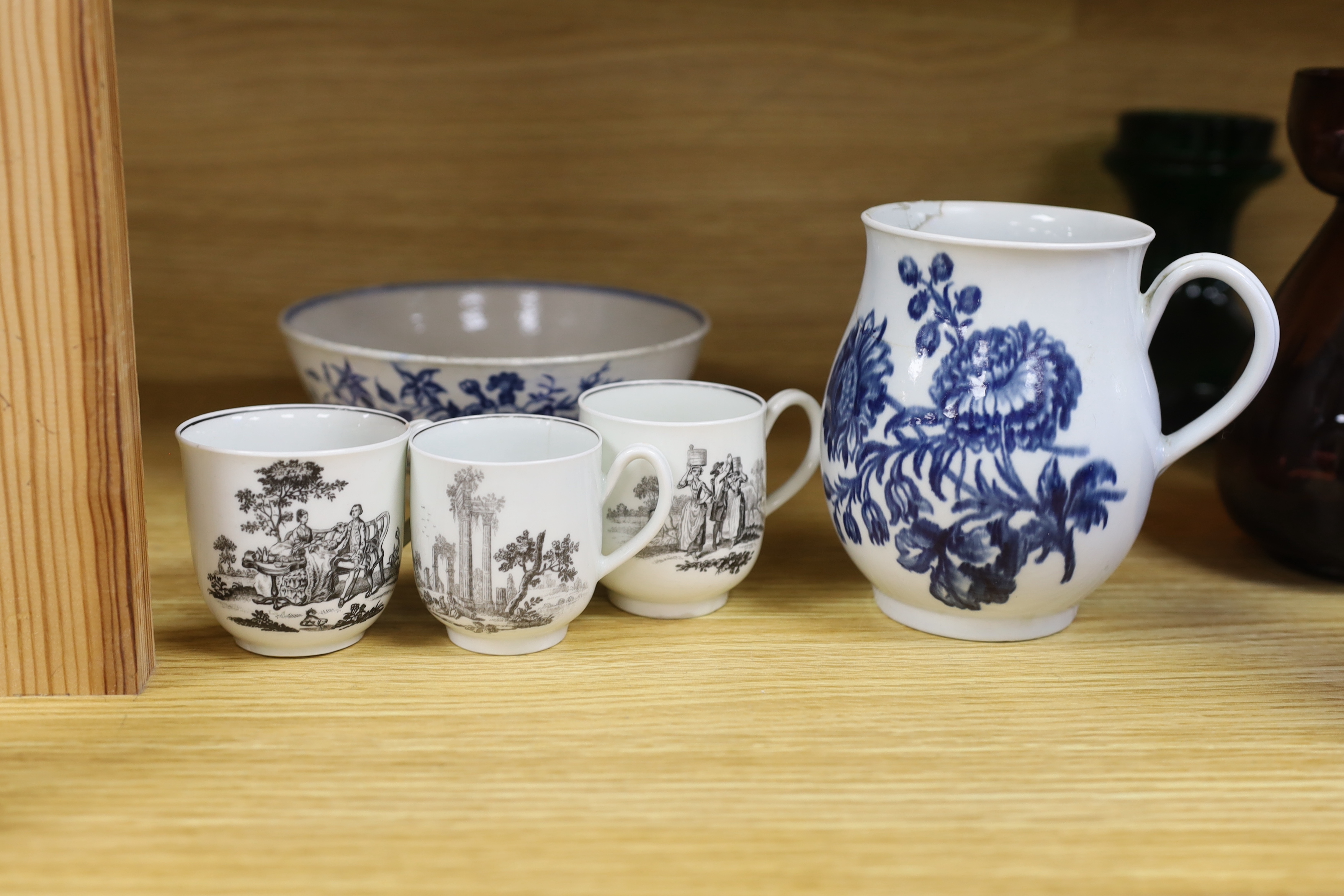 18th century Worcester comprising two floral bowls, two jugs, and three transfer printed cups, the largest 15cm in diameter (7)